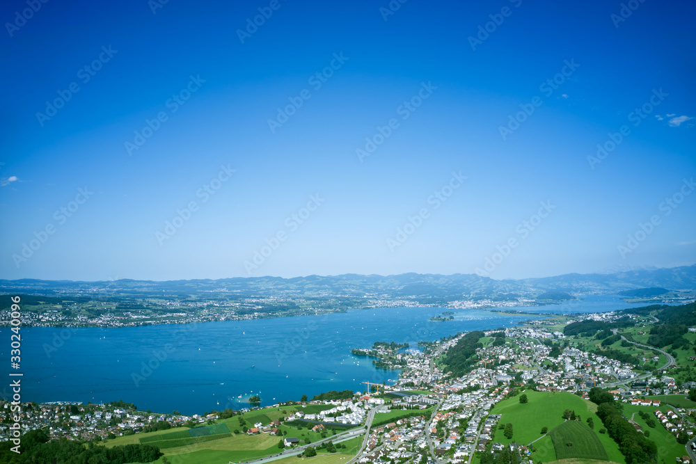 Aerial high-angle shot of beach and town scenery against the blue sky