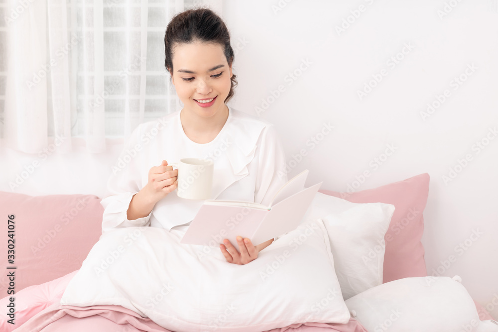 Amazing time to relax with favourite book and coffee. White bedroom shot Amazing time to relax with favourite book and coffee. White bedroom shot