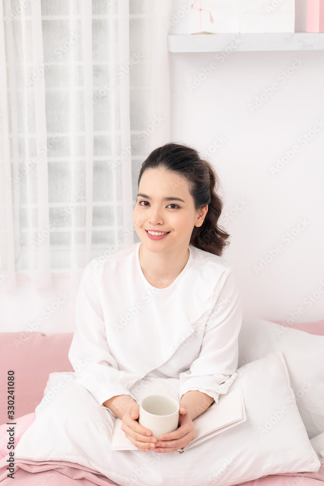 Amazing time to relax with favourite book and coffee. White bedroom shot Amazing time to relax with favourite book and coffee. White bedroom shot