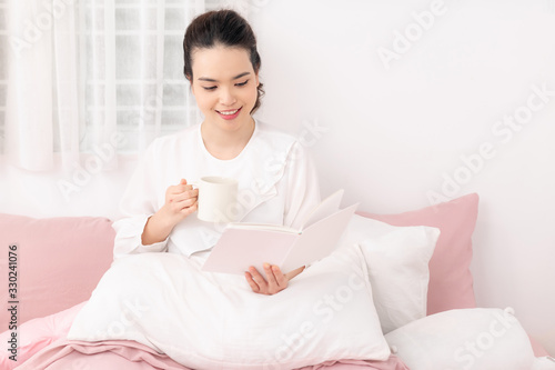 Amazing time to relax with favourite book and coffee. White bedroom shot