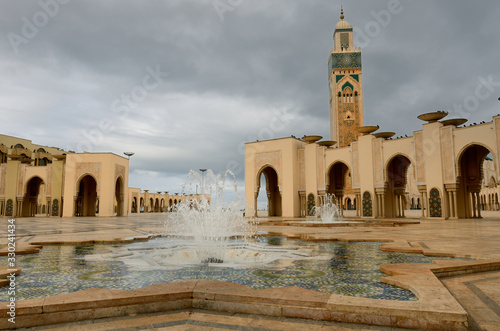 Minaret and fountains at the Hassan II Mosque in Casablanca Morocco on a stormy day