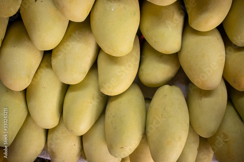 Fresh mangoes on a shelf photo