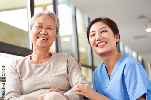 portrait of happy nursing home resident and caregiver