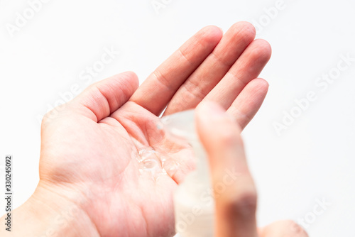 Alcohol gel on human hand with white background. Hand Sanitizer and Hygiene concept. Prevent the spread of germs and bacteria and avoid infections corona virus.
