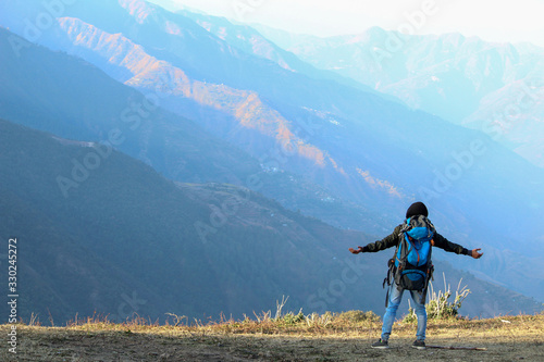 Hiker in the Mountains of Himalayas photo