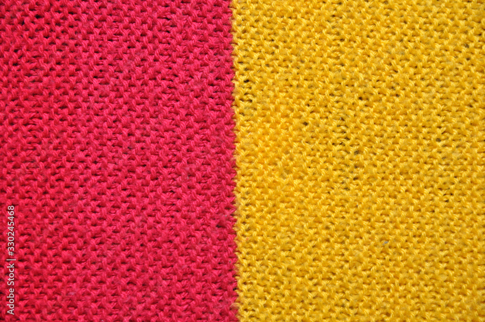Fibrous texture of woolen fabric. Yellow and red. Background Fibrous texture of woolen fabric. Yellow and red. Background