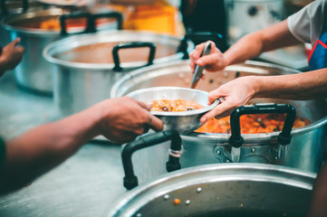 Feeding the poor to hands of a beggar, feeding food for beggar poverty concept