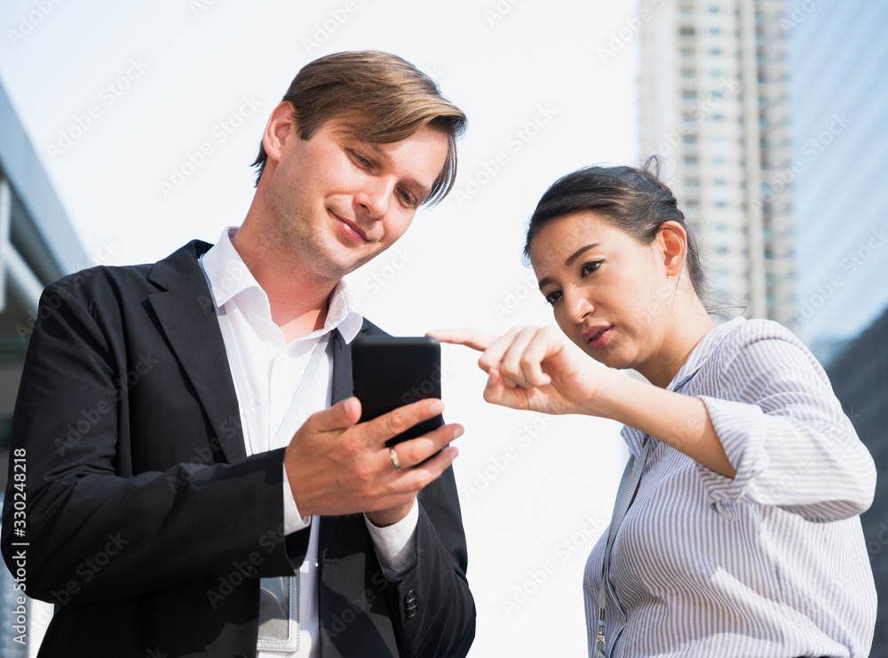 Portrait of businessman and woman looking at phone Portrait of businessman and woman looking at phone