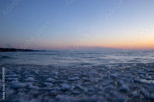 Icy water floating at sunset  South Haven Lake Michigan long exposure