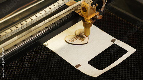 Canvas Print Laser cutting beam high precision on a plywood sheet