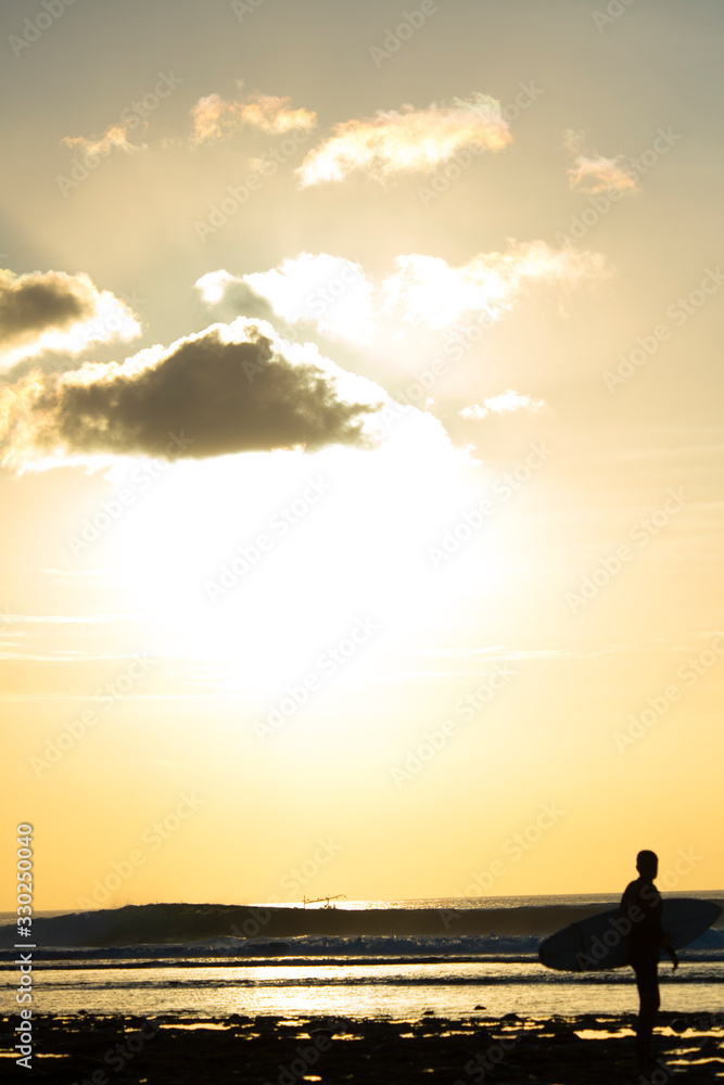 Surfer enjoying the sunset after a surf session