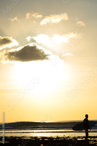 Surfer enjoying the sunset after a surf session