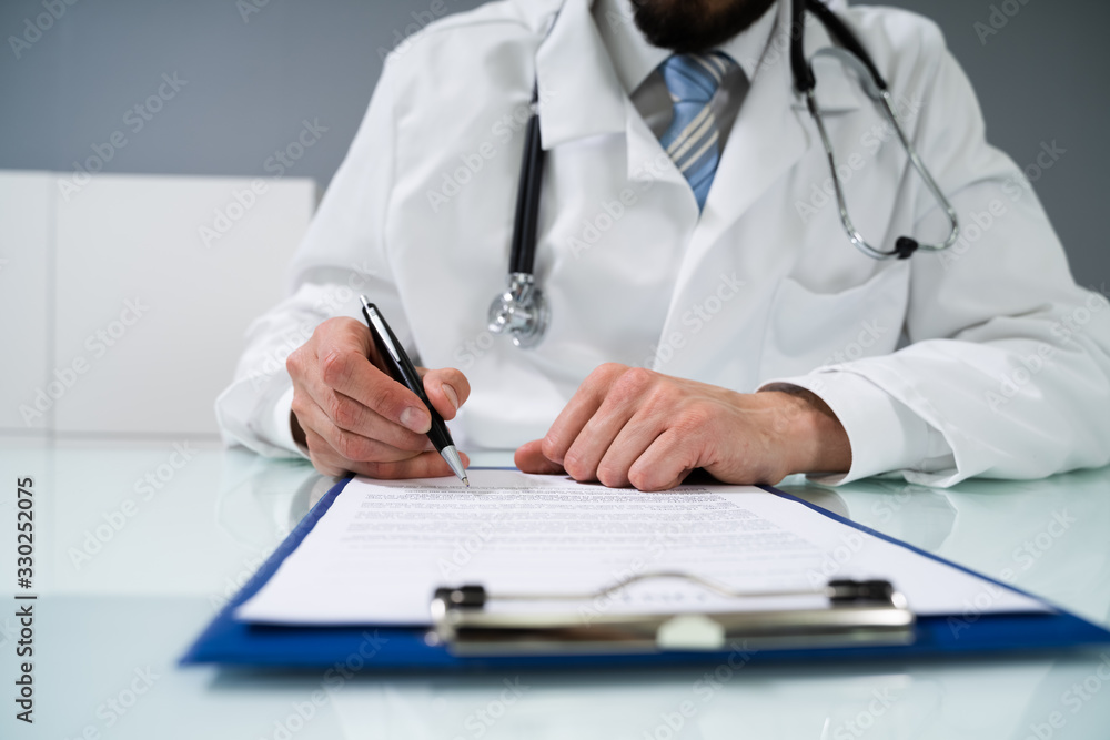 Doctor's Hand Signing Document Doctor's Hand Signing Document