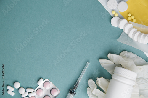 Layout of Flatley tablets with an empty space. Medicines, tablets and a syringe on a blue background. Virus protection and 2019-ncov. photo