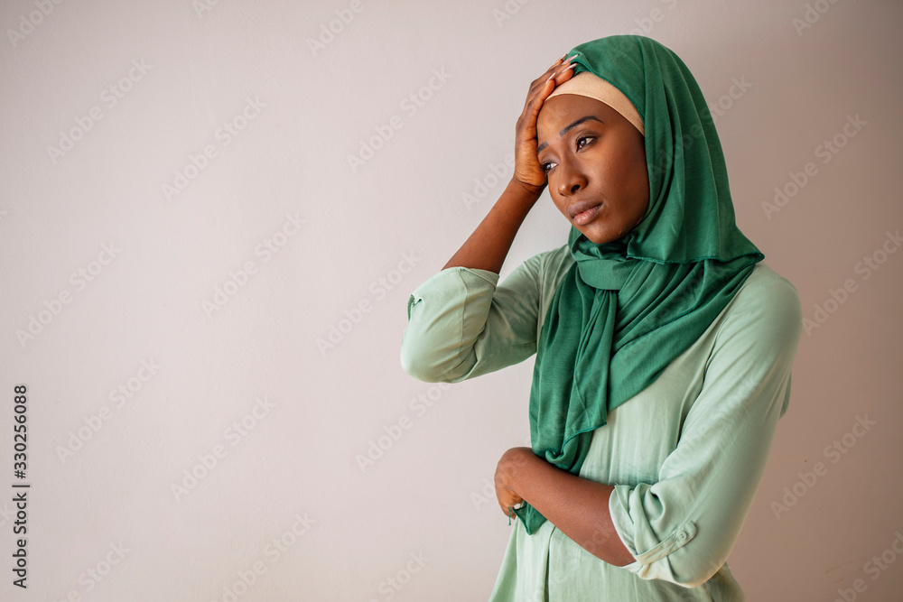 Elegant pretty muslim woman feeling headache painful. Muslim woman having a headache. Muslim woman having a severe headache. Female office worker tired and feel bad. Stress and health. Elegant pretty muslim woman feeling headache painful. Muslim woman having a headache. Muslim woman having a severe headache. Female office worker tired and feel bad. Stress and health.