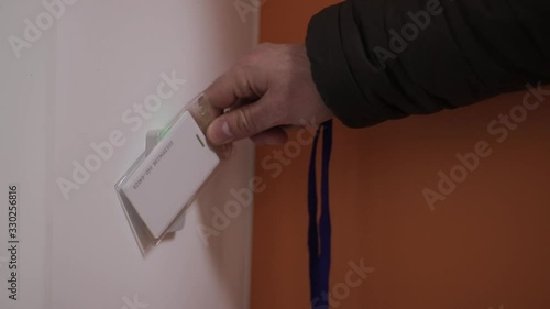 Close-up - the man put the card on checkpoint and open a door in building