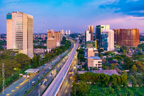 Jakarta, Indonesia - 30th December 2018: South Jakarta Cityscape at sunset, with beautiful pastel colored sky. Rail track construction is visible in the foreground.