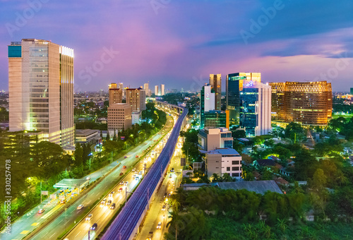 Jakarta, Indonesia - 30th December 2018: South Jakarta Cityscape at sunset, with beautiful pastel colored sky. Rail track construction is visible in the foreground. © HaniSantosa