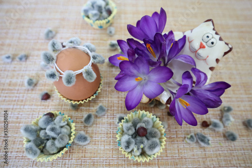 Crocuses with a cat figure and Easter eggs