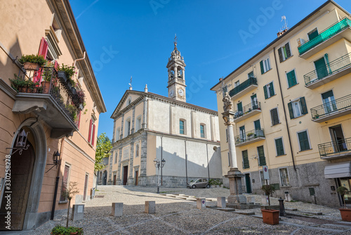 Historic center of the town of Oggiono with the church of S. Eufemia (17th century), street 1 Maggio . Oggiono is a small town on Lake Annone in northern Italy, province of Lecco photo