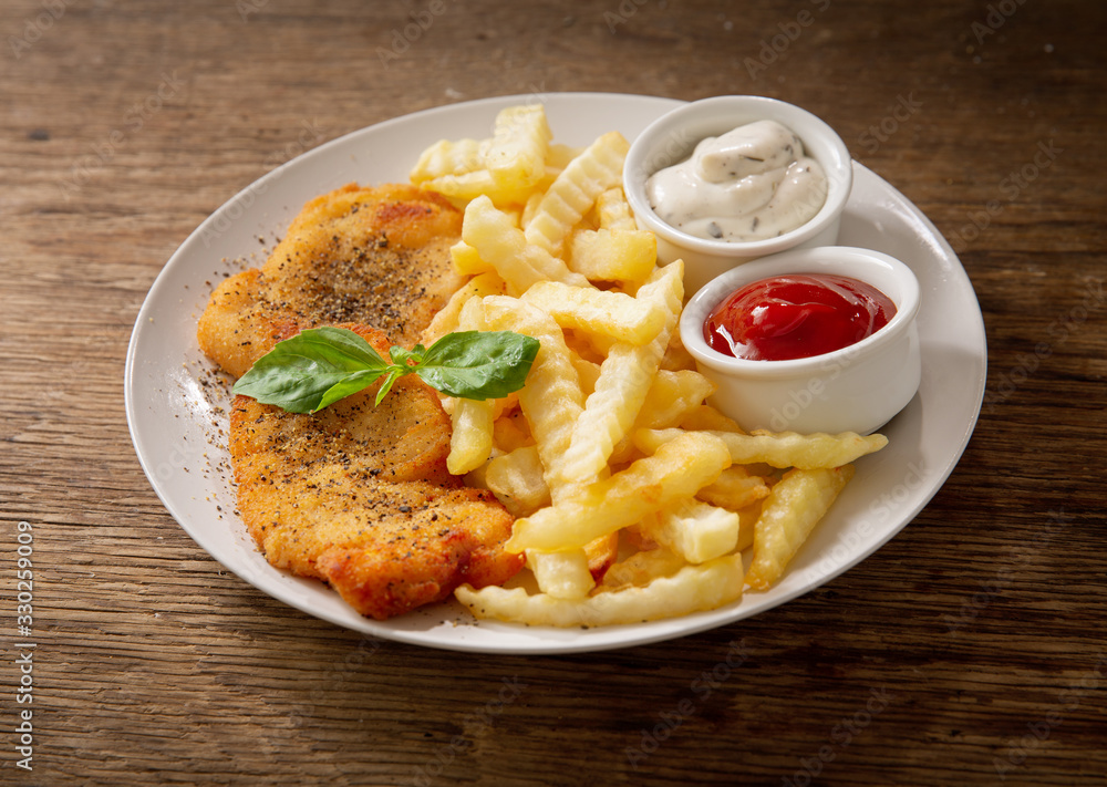 plate of chicken schnitzel and french fries plate of chicken schnitzel and french fries