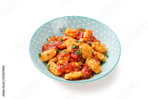 Homemade italian gnocchi with red tomato sauce and parmesan cheese isolated on white background