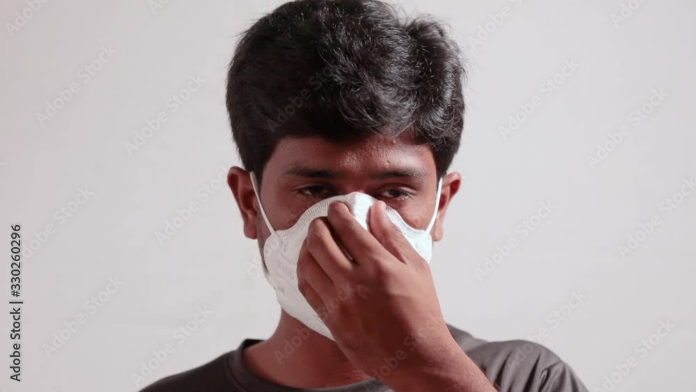 Concept of showing of covid-19 outbreak protection by wearing mask - young man wearing medical n95 face mask on isolated background. Concept of showing of covid-19 outbreak protection by wearing mask - young man wearing medical n95 face mask on isolated background.