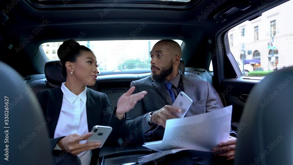 Successful male and female bosses getting to business meeting in corporate workspace checking information for presentation, executive managers in formal wear using smartphones for marketing Successful male and female bosses getting to business meeting in corporate workspace checking information for presentation, executive managers in formal wear using smartphones for marketing