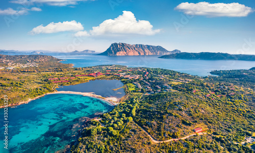 Fototapeta Naklejka Na Ścianę i Meble -  View from flying drone. Astonishing summer scene of Salina Bamba beach with Tavolara mountain on background. Spectacular morning view of Sardinia island, Italy, Europe.
