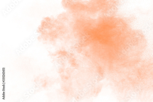 Plakat Freeze motion of brown powder exploding. Abstract design of brown dust cloud against white background.