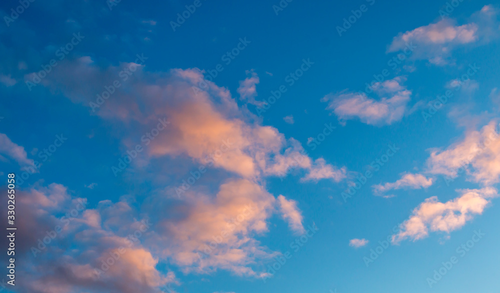 Blue sky with golden clouds. the last rays of the evening sun Blue sky with golden clouds. the last rays of the evening sun