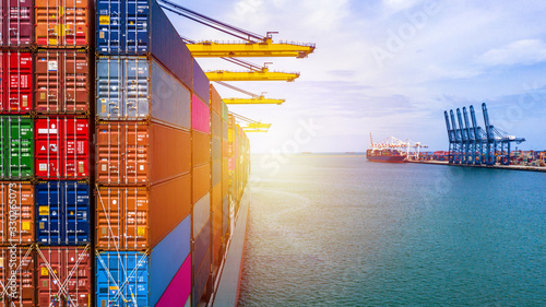 Container ship carrying container box in import export with quay crane, Global business cargo freight shipping commercial trade logistic and transportation oversea worldwide by container vessel