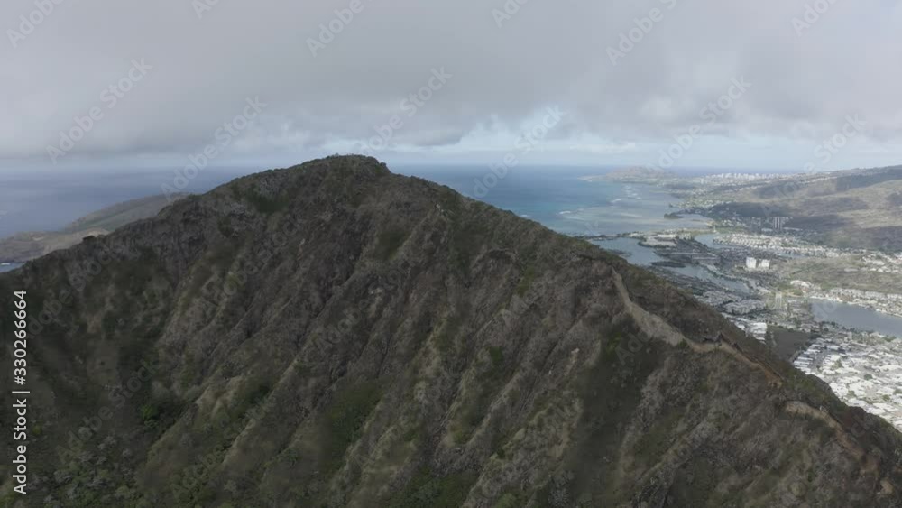 Drone views of a mountain top overlooking the beautiful city in Hawaii Drone views of a mountain top overlooking the beautiful city in Hawaii