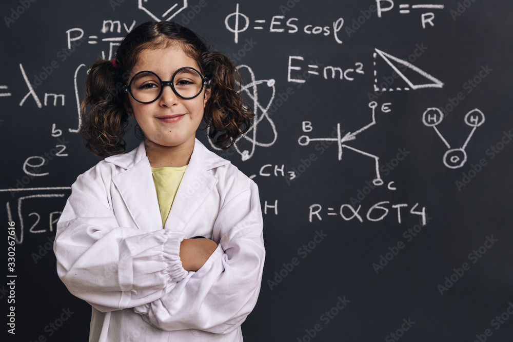 cheerful little girl scientist with glasses