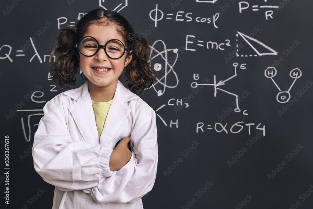 smiling little girl scientist in lab coat