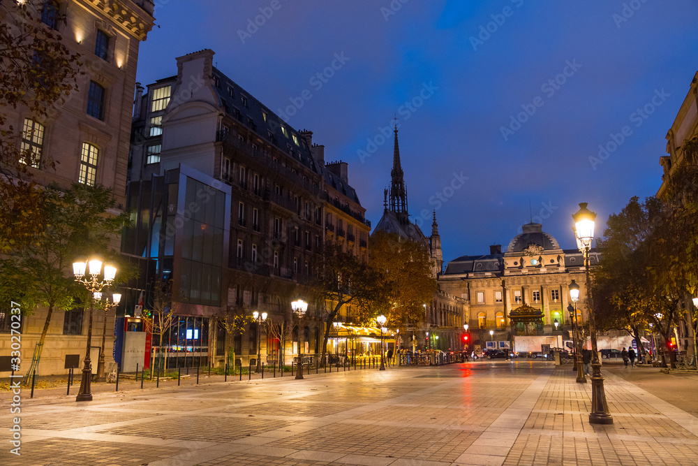 Place Louis Lépine, Paris, France. Beautiful shot of the square, the Palace of Justice, the Holy Chapel (Sainte-Chapelle). Typical street lamps. Paris by night.
