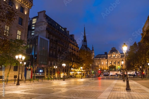 Place Louis Lépine, Paris, France. Beautiful shot of the square, the Palace of Justice, the Holy Chapel (Sainte-Chapelle). Typical street lamps. Paris by night.