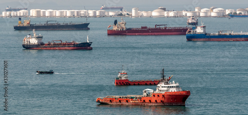 Fotografie Ships awaiting fueling at an oil tank farm near Singapore