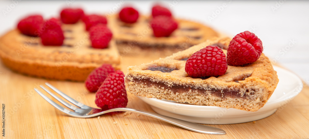 Dessert Raspberry Pie cake with strawberry or Fruit in a round bread for Break time or a party shot at the top view and copy space on a white wooden table. Dessert Raspberry Pie cake with strawberry or Fruit in a round bread for Break time or a party shot at the top view and copy space on a white wooden table.