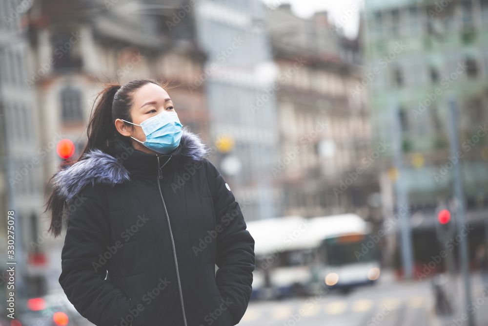 The image face of a young Asian woman wearing a mask to prevent germs, toxic fumes, and dust. Prevention of bacterial infection in the air around the streets and gardens. The image face of a young Asian woman wearing a mask to prevent germs, toxic fumes, and dust. Prevention of bacterial infection in the air around the streets and gardens.