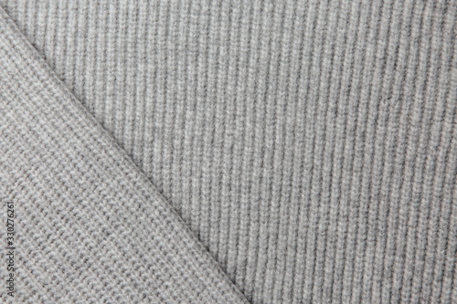 Grey knitted fabric texture. Product from wool. Handwork