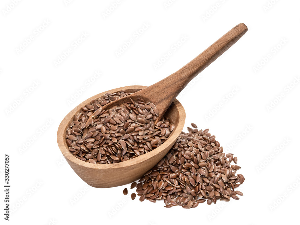 Linseeds or flax seed in a small oval wooden bowl with a spoon and pile next to it seen obliquely from front and above and isolated on white background Linseeds or flax seed in a small oval wooden bowl with a spoon and pile next to it seen obliquely from front and above and isolated on white background