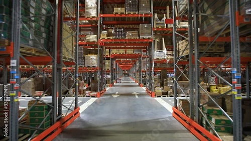 Warehouse with cardboard boxes inside on pallets racks, logistic center.