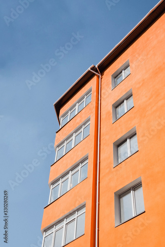 Orange building under a blue cloudless sky