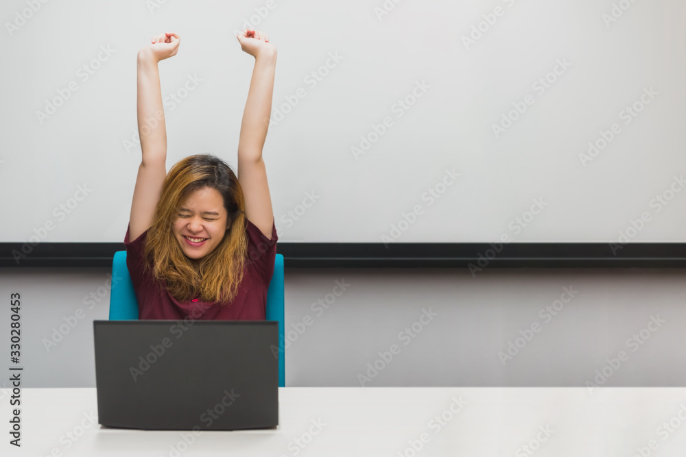 Woman working by laptop in office with happy Woman working by laptop in office with happy