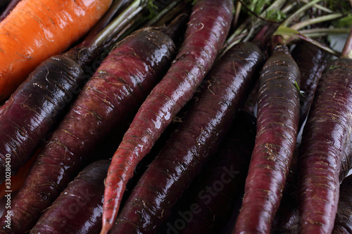 Carrots and unusual violet carrots background