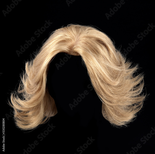 Blonde hair wig on black background