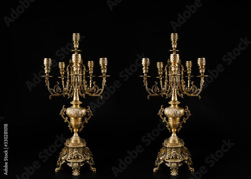 Принти на полотні two classic bronze chandeliers on a black background, ancient candlesticks studi