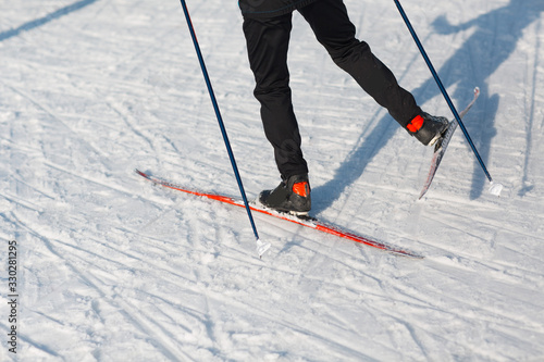 Skier rides on the skiing track on ski