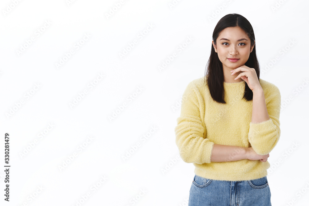 Successful young asian woman in yellow sweater looking determined and confident camera, touching chin thoughtful, feeling ready tackle tasks, finish programming courses and starting career Successful young asian woman in yellow sweater looking determined and confident camera, touching chin thoughtful, feeling ready tackle tasks, finish programming courses and starting career